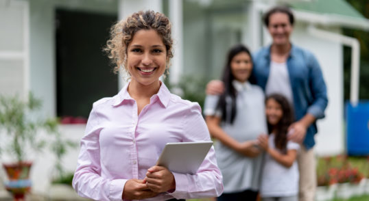 real estate agent showing a family a house