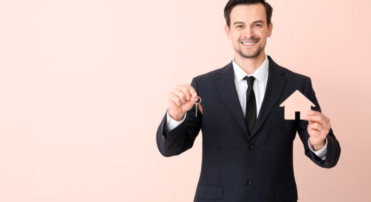 male real estate agent with key