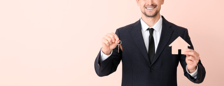 male real estate agent with key